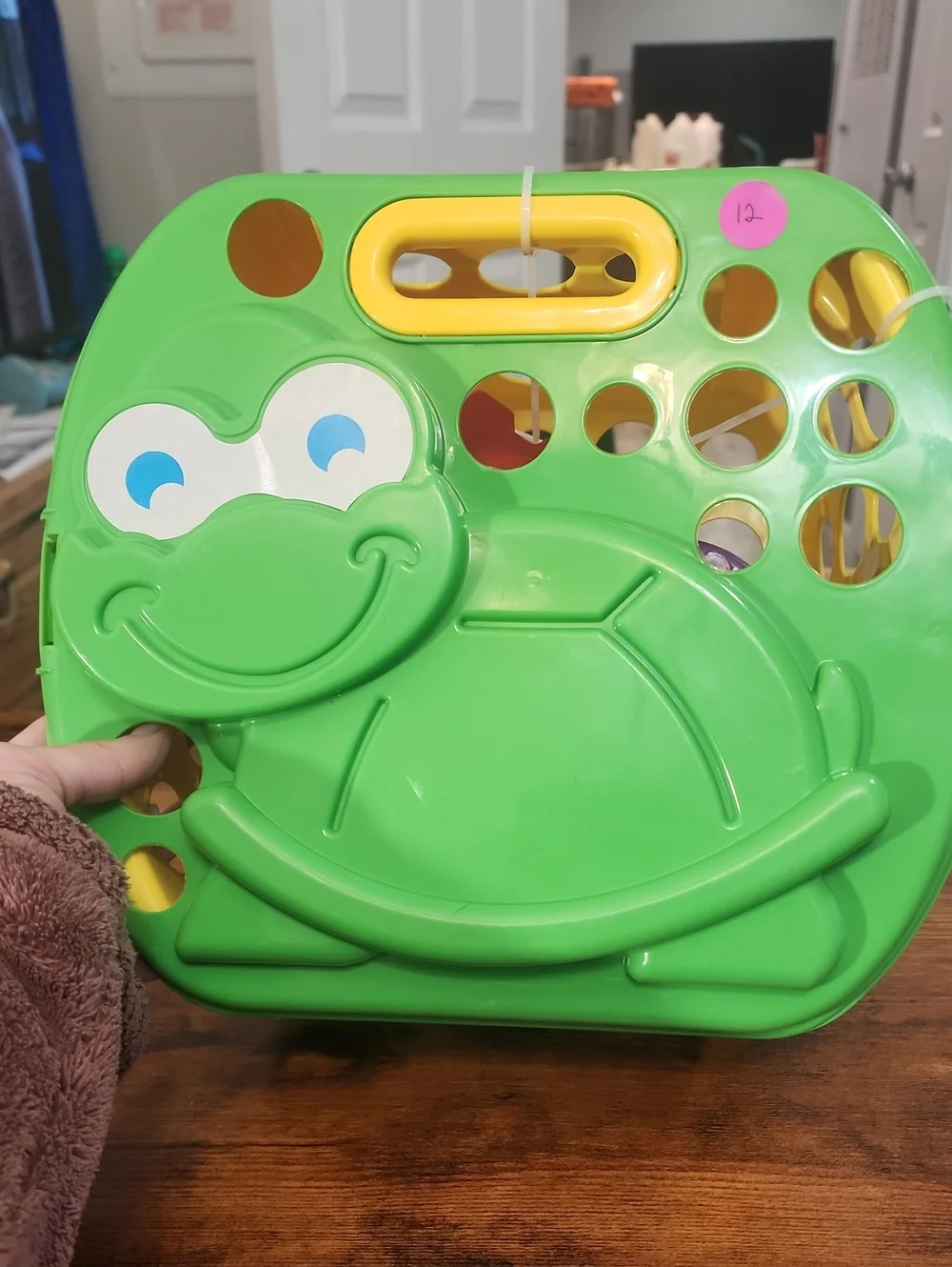 Green Frog Shape Box With Sand Casle Stuff For The Beach In It. And A Blue Fish